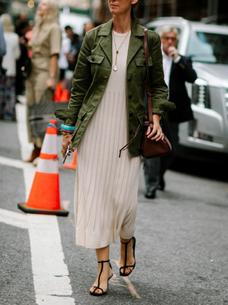 woman in mid-length jacket and a dress