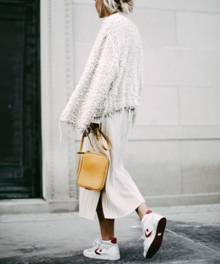 Woman in midi dress and white canvas shoes