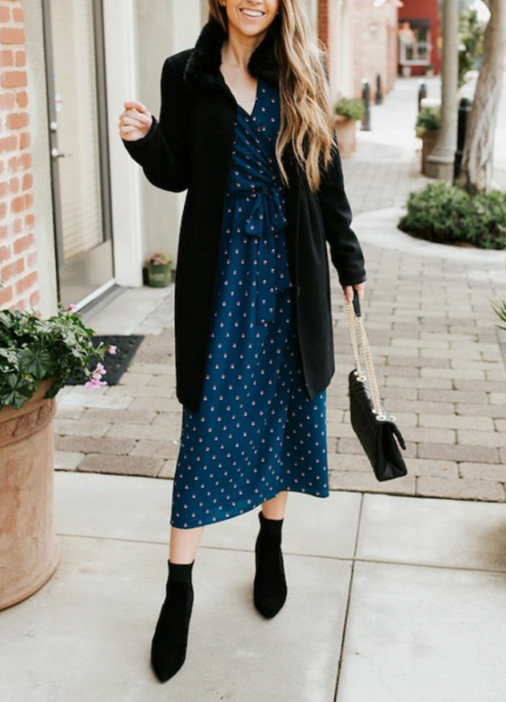 woman in blue midi dress with polka dots