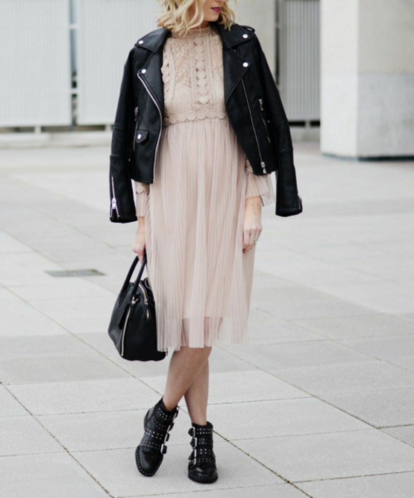 woman in pink midi dress and a black leather jacket