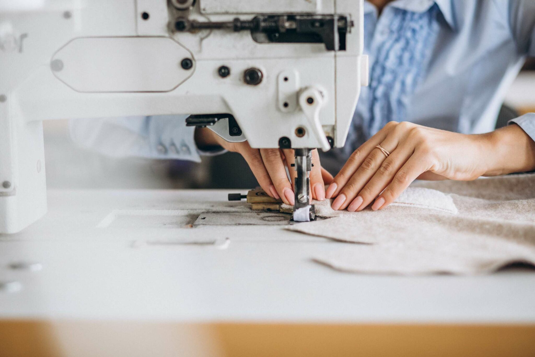 the worker sewing the cloting
