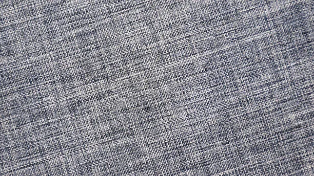 Close-up of blue grey linen blend fabric showing detailed woven texture and natural fabric weave pattern